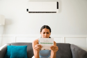 Woman sitting indoors worried about a power bill