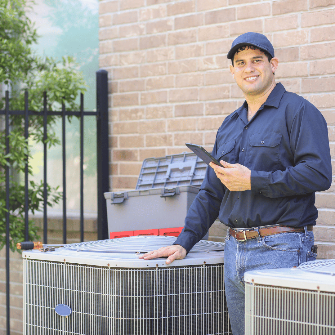 HVAC technician standing near an AC unit